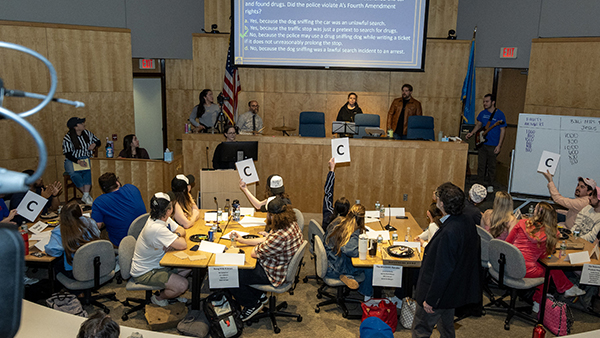 Student teams answer a question