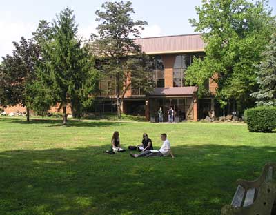 students in a field at a campus