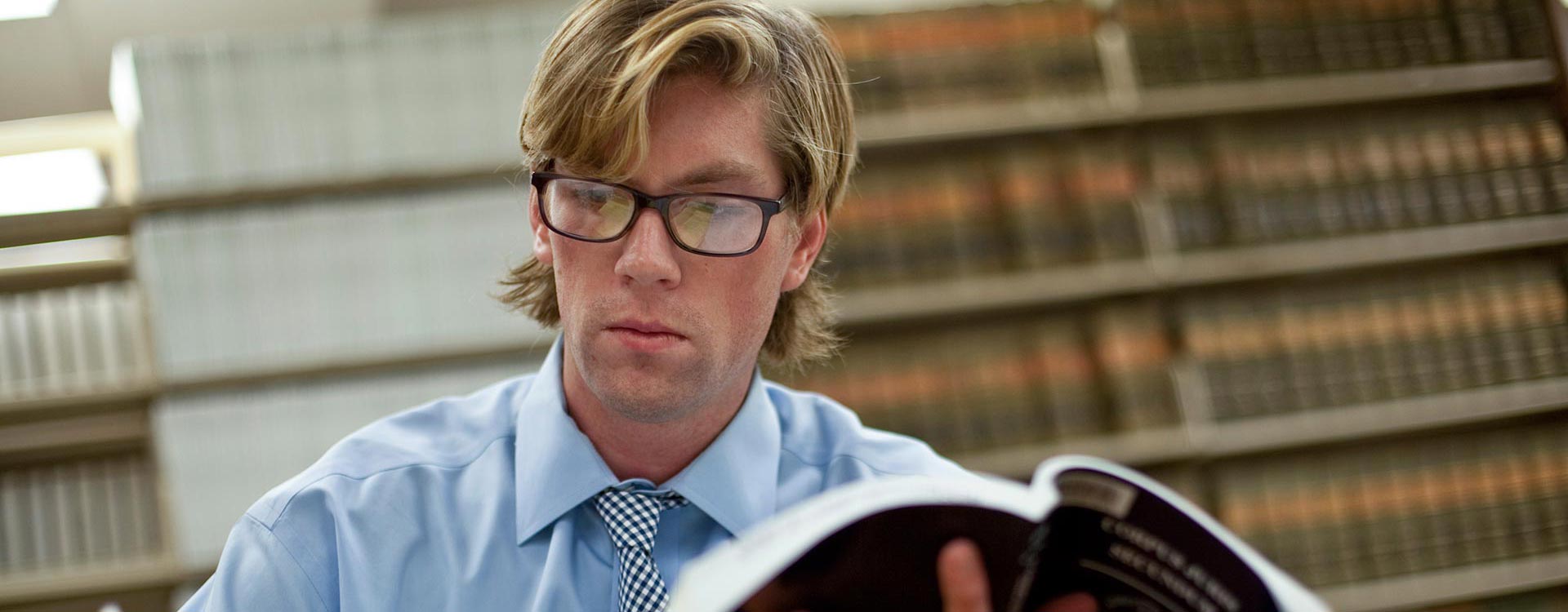 Student holding an open text book