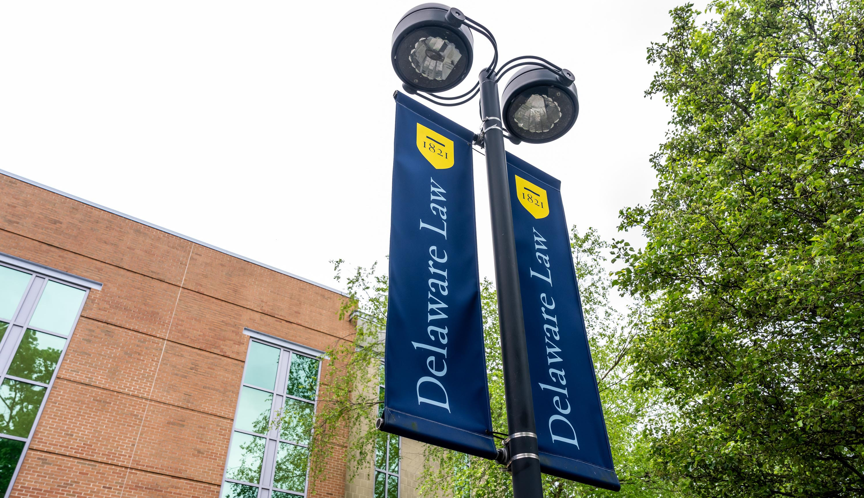 Light post with two Delaware Law banners hanging from it