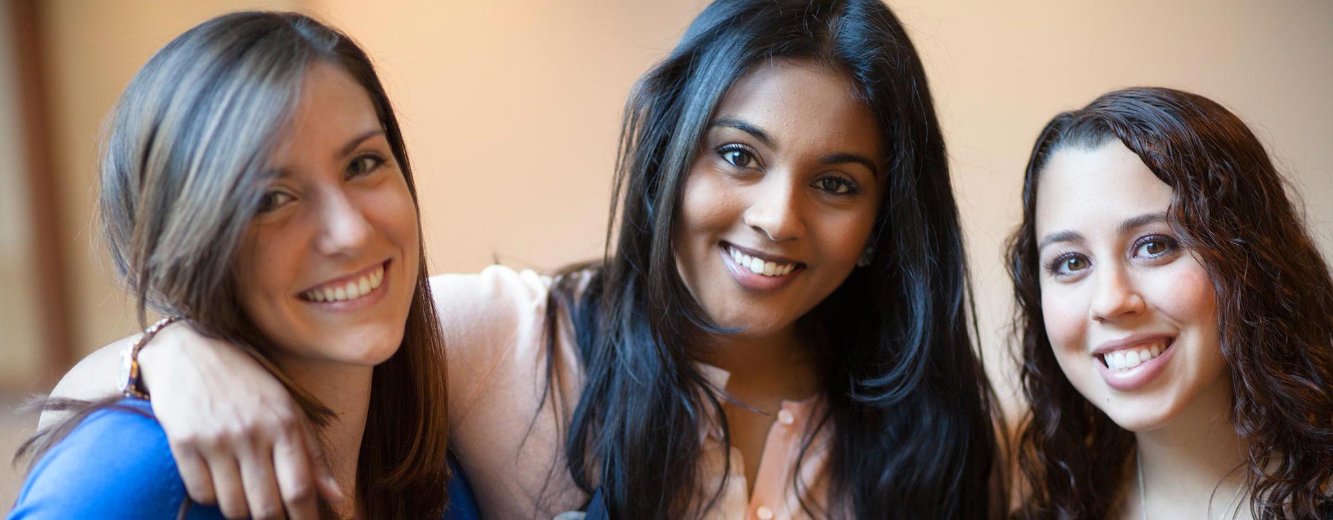 Three students smiling