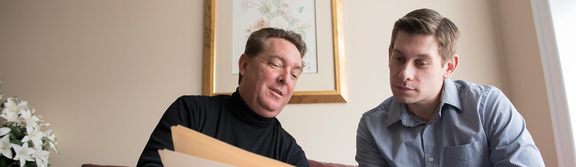 Two people looking at a folder