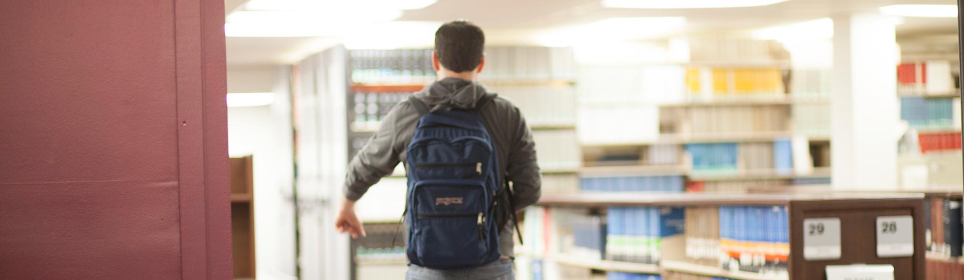 Man walking away from the camera wearing a backpack
