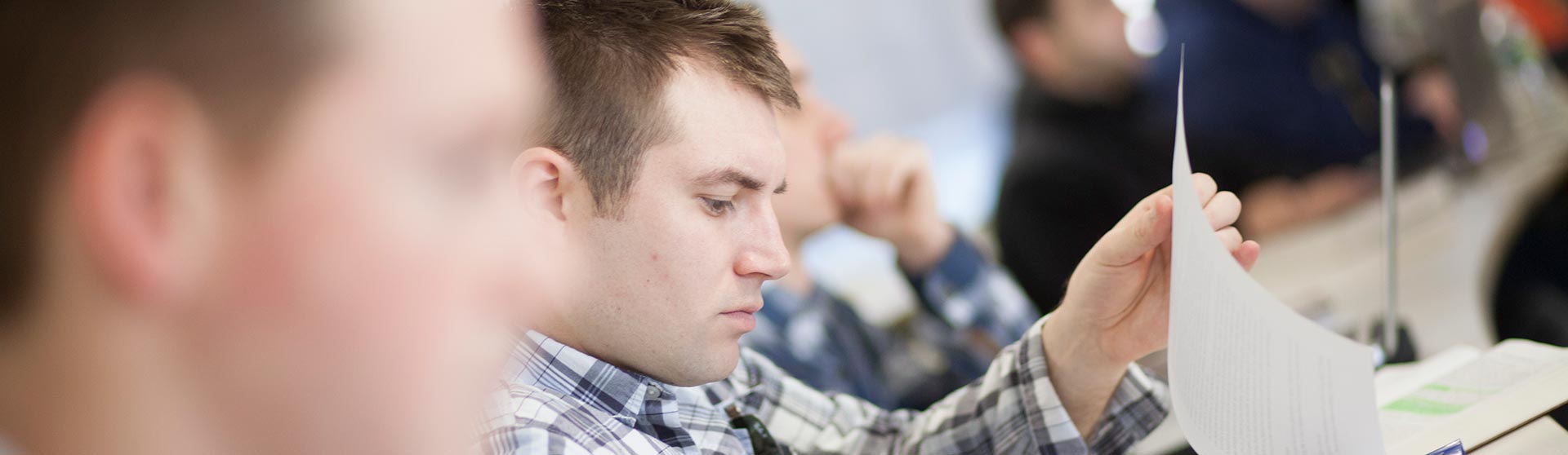 Students in class looking at papers