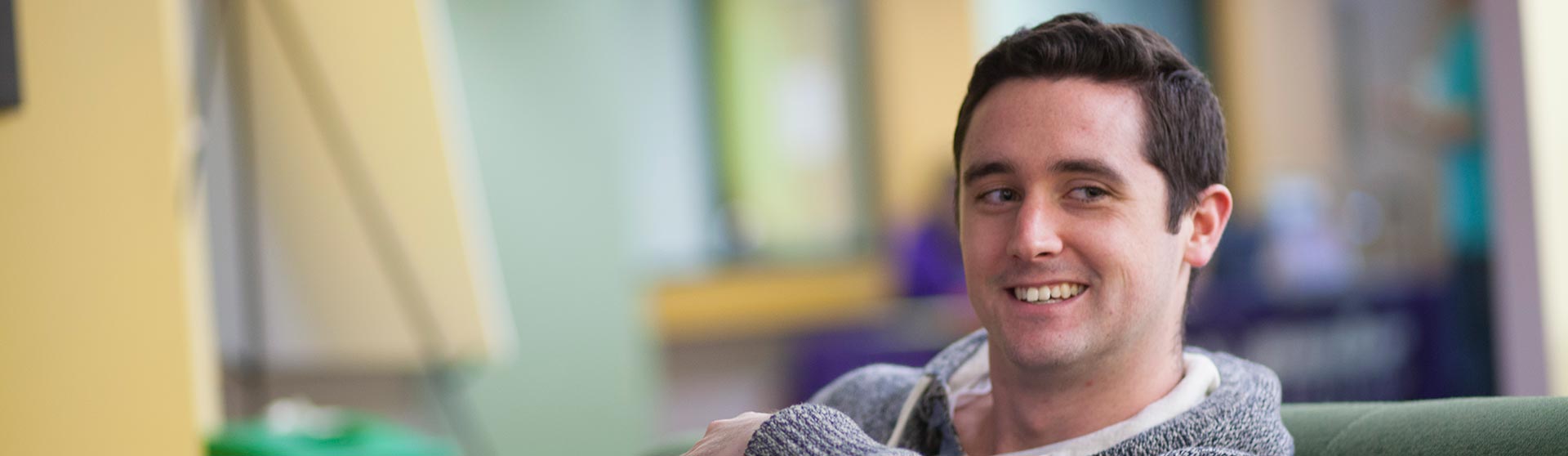 Smiling male student in lounge